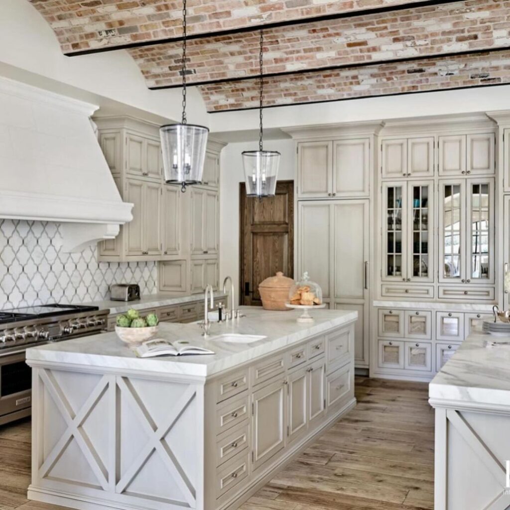Kitchen with white cabinets and brick ceiling