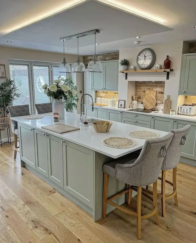 A kitchen with a spacious island and wooden floors