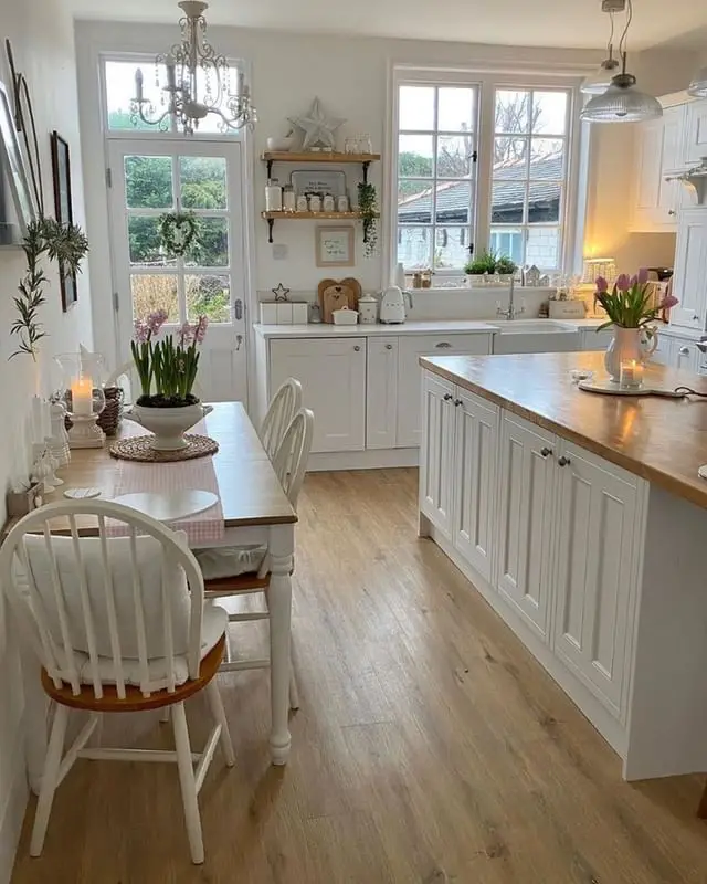 Kitchen with wooden floors and white cabinets