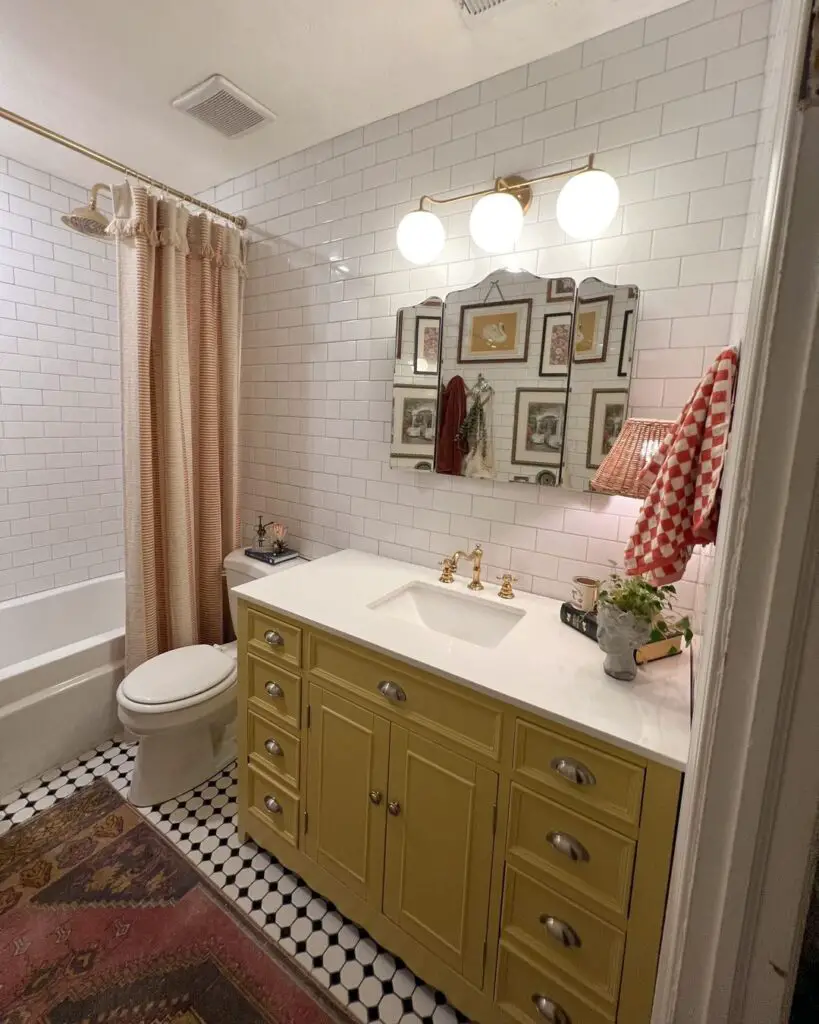 Vintage bathroom with yellow vanity and tiled walls