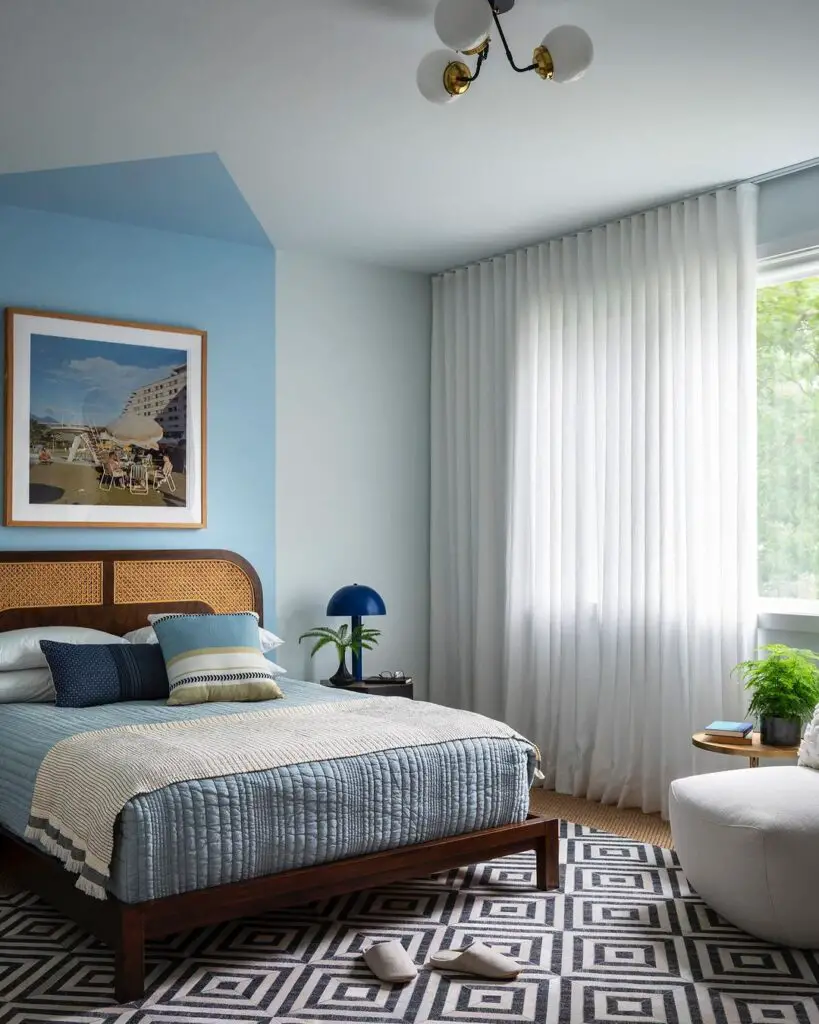 Blue coastal bedroom with rattan headboard
