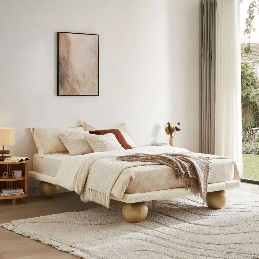 Serene bedroom with ball-footed bed and earthy color palette