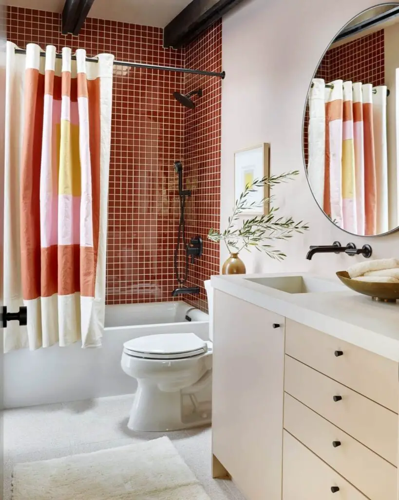 Vintage bathroom with red tiles and striped curtain