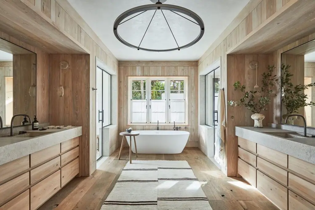 Wooden bathroom with tub and round light