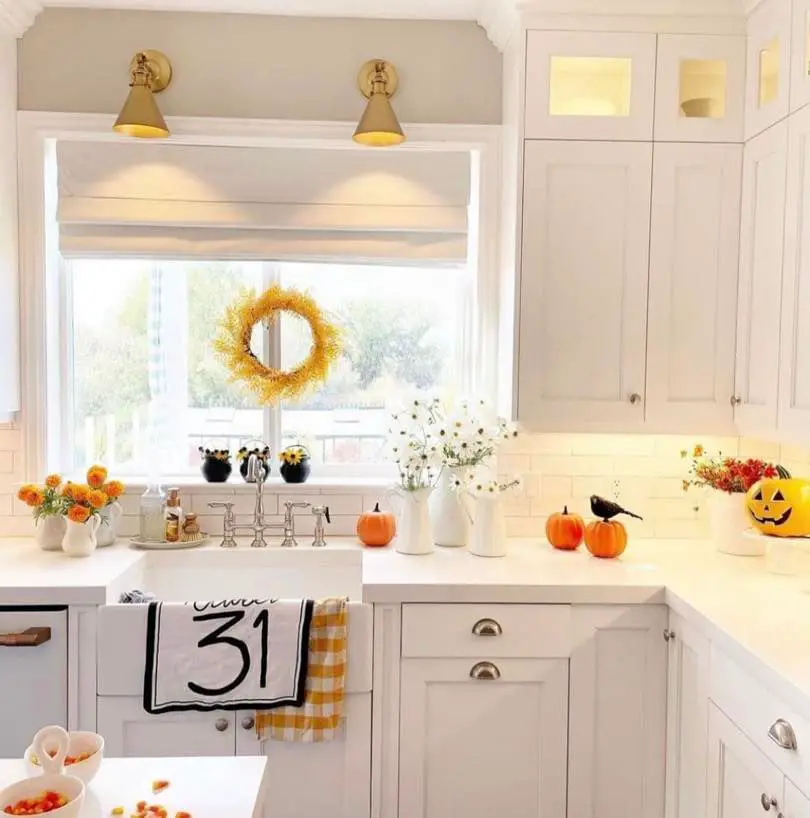 White kitchen with fall decorations and pumpkins
