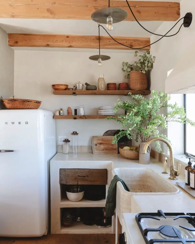 Compact kitchen with white walls wooden shelves and retro refrigerator