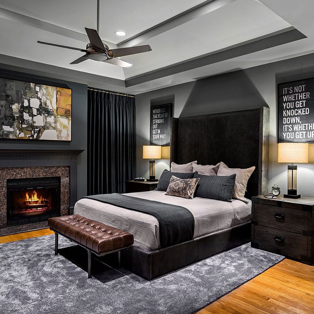 Masculine bedroom with fireplace motivational art and dark decor