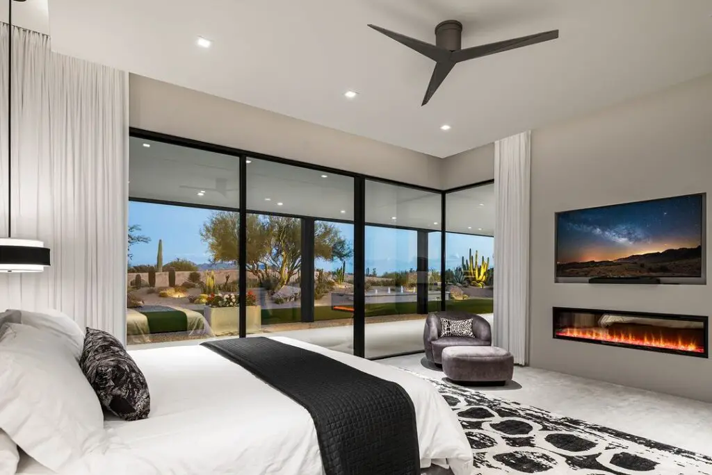 Luxury bedroom with desert view and dual fireplaces