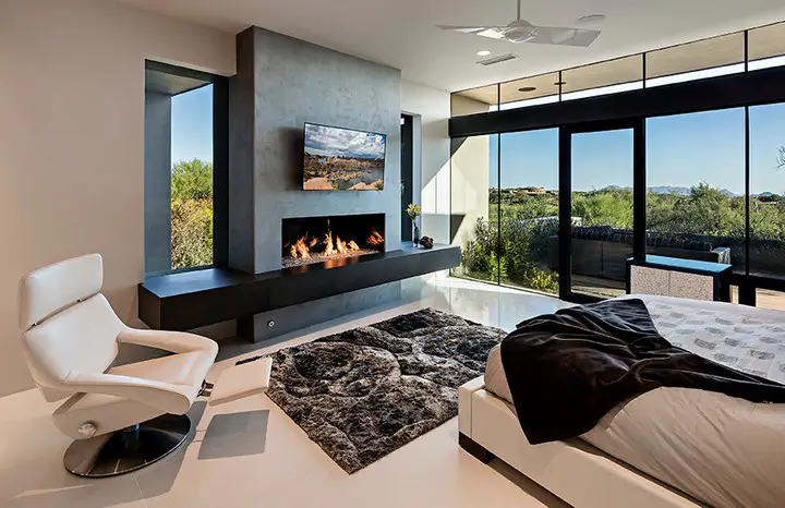 Modern bedroom with fireplace and panoramic windows