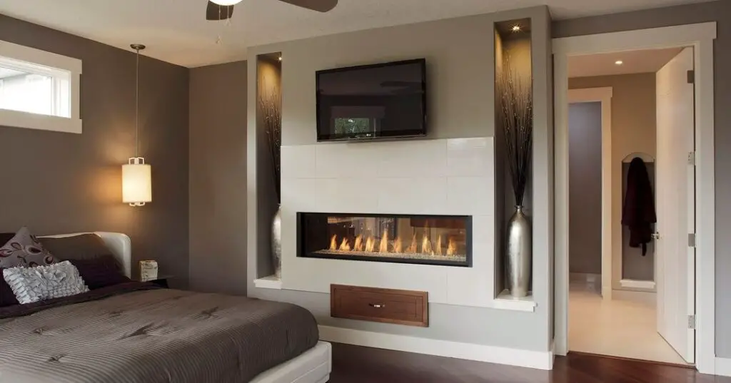 Modern bedroom with fireplace TV and soft lighting