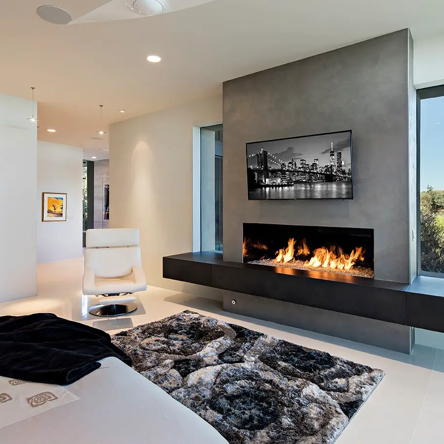 Modern bedroom featuring fireplace wall and city skyline art